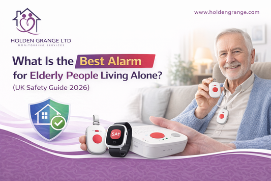 Smiling older man on a sofa holding up a pendant alarm, with watch and base unit shown