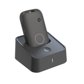 Black electronic device on a matching stand against a white background